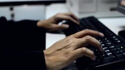 HD: Asian man typing on a computer keyboard. Stock Footage