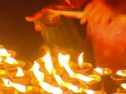 MS TU Woman bathed in orange light changing  wick of candle  / Kathmandu, Central, Nepal Stock Footage