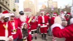 CLEAN : People dressed as Santa raise money in New York News Clip