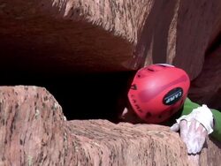ECU Looking down on climber stuck in very wide crack trying to get out and climb in rest of rock and he struggling and very exhausted  / Zion,UT,USA Stock Footage