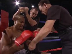 CU ZO MS Trainer lacing up boxing glove and giving pep talk while another man squeezes water over boxer's head / Jacksonville, Florida, USA Stock Footage