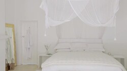 White bed and canopy in luxury bedroom Stock Footage