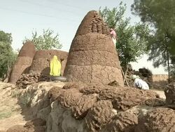 Women making pile of manure to be burned into fuel Stock Footage