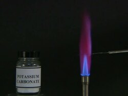A flame test used in chemistry to detect the presence of certain metal ions, based on each elements characteristic emission spectrum (Potassium Carbonate) Stock Footage