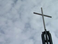 "City top crucifix, simple and white, backdrop of fast moving clouds" Stock Footage