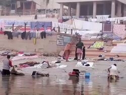 MS People washing clothes at bank of river / Varanasi, Uttar Pradesh, India Stock Footage