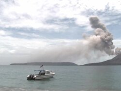 Wide shot of speedboat with erupting volcano in background, Krakatoa, Indonesia, November 2010 Stock Footage