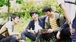 WS Japanese students using digital tablet in the park Stock Footage