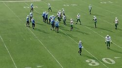 WS SLO MO Aerial view. Professional football teams break huddle and come to line of scrimmage, quarterback takes snap and passes to wide receiver who catches and runs
 with football until tackled by defensive linebackers. Stock Footage