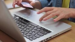 Woman's hands holding credit card and using laptop, online shopping Stock Footage