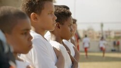 Brazilian youth soccer team hold hands over hearts for national anthem Stock Footage