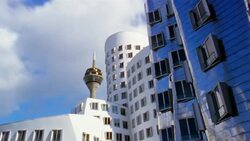 White clouds pass over modern office buildings in the Der Neue Zollhof complex in Dusseldorf, Germany. Stock Footage