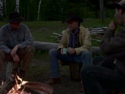 cowboys sit around a fire Stock Footage