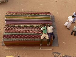 Two mauritanian men lying down on some fabrics Stock Footage