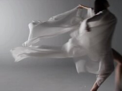 woman with silk draped around her running across screen Stock Footage