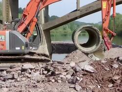 MS Shot of excavator loaded with cement pipe bridge construction site near Saar river / Wiltingen, Rhineland Palatinate, Germany Stock Footage