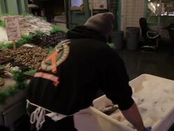 Pike Place seafood market employees set up market Stock Footage