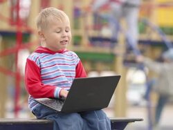 boy with a laptop on the playground Stock Footage