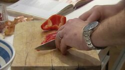Set up shots of a man preparing minced beef with red pepper and onions News Clip