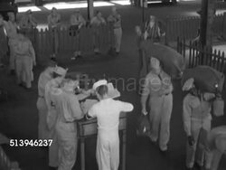1952: KOREAN WAR: U.S. SOLDIERS: HA WS United States soldiers carrying duffle bags walking by table on dock, pier, soldiers checking in by calling names (SOT) to officers at table. Korean Conflict, transport. Instructional Video