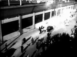 B/W 1930s high angle people running from + throwing tear gas during auto strike / Flint, Michigan Stock Footage