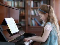 Little girl playing the piano Stock Footage