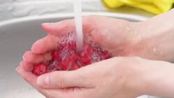 raspberries under running water Stock Footage