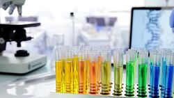 Genetic engineering scientist placing vial into test tube rack Stock Footage