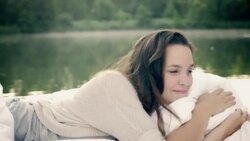 Woman awakening on lake Stock Footage