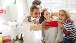Young couples taking selfie in sunny apartment kitchen Stock Footage