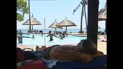 Tourists by pool and doing water aerobics News Clip