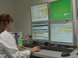 Technician at work in Proton Therapy Centre lab News Clip