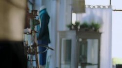 Shopkeeper enters clothing store Stock Footage