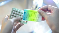 Hands Pressing Pill out of  Contraceptive Stock Footage