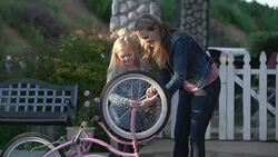 MS Mother teaching her daughter how to fix her bicycle Stock Footage