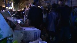 Mardi Gras participants walk past trash on Bourbon Street in New Orleans. Stock Footage