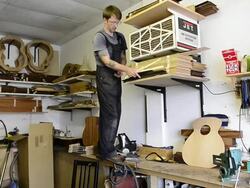 Craftsman 'Luthier' Nigel Forster making hand made Guitars Stock Footage