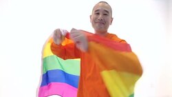 Mature adult male spinning holding gay pride flag and smiling Stock Footage