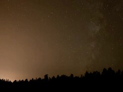 WS T/L Milky Way moving across sky over forest / Flagstaff, Arizona, United States Stock Footage