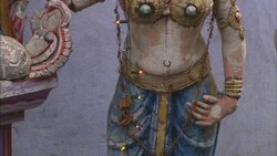 A string of lights hangs in front of the sculpture of a Hindi woman. Stock Footage
