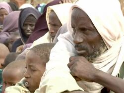 Refugees sitting on the ground Stock Footage