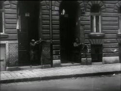 B/W 1956 man in doorway fires rifle / Hungarian uprising Stock Footage