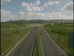 T/L MWA high angle view of traffic on A 417, Gloucestershire, through countryside (Driving on left hand side of road) Stock Footage