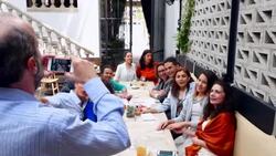 MS TU PAN Man taking multigenerational family portrait with smartphone during dinner party in restaurant Stock Footage
