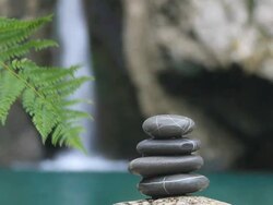 Balanced stones on waterfall background Stock Footage