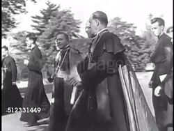 1936: PACELLI TOURING USA: Cardinal Eugenio Pacelli (later Pius XII) walking w/ other clergy outside, WS People gathered at indoor rally w/ large American banners hanging on walls. Instructional Video