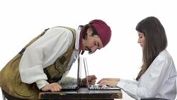 Computer hacker disguised in pirate stealing data from a businesswoman's computer. Stock Footage