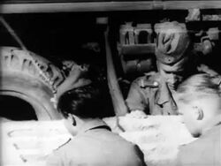 B/W 1961 close up soldiers guiding concrete slab onto mortar-covered wall / Berlin Wall construction Stock Footage