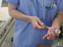 Caucasian nurse loading syringe with medication Stock Footage