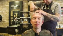 Male Hair stylist cutting male clients hair Stock Footage